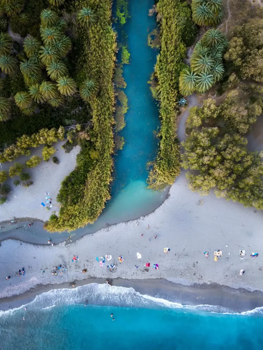 From above: the river at Preveli running between palms to the beach and the sea