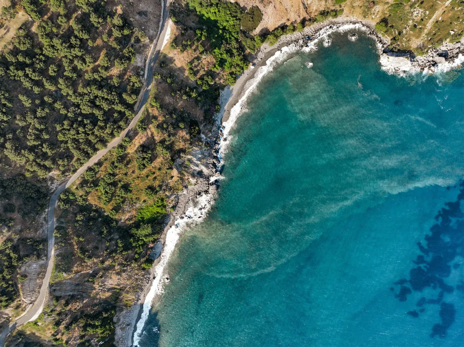 From above: the road along the hillside at Rodakino and the turquoise sea below