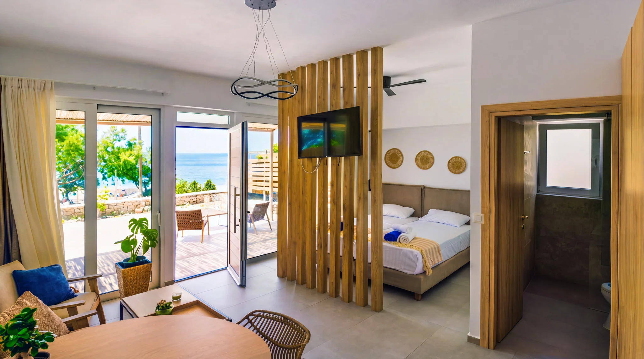 The full studio with sitting area, kitchenette, twin beds and an open terrace door