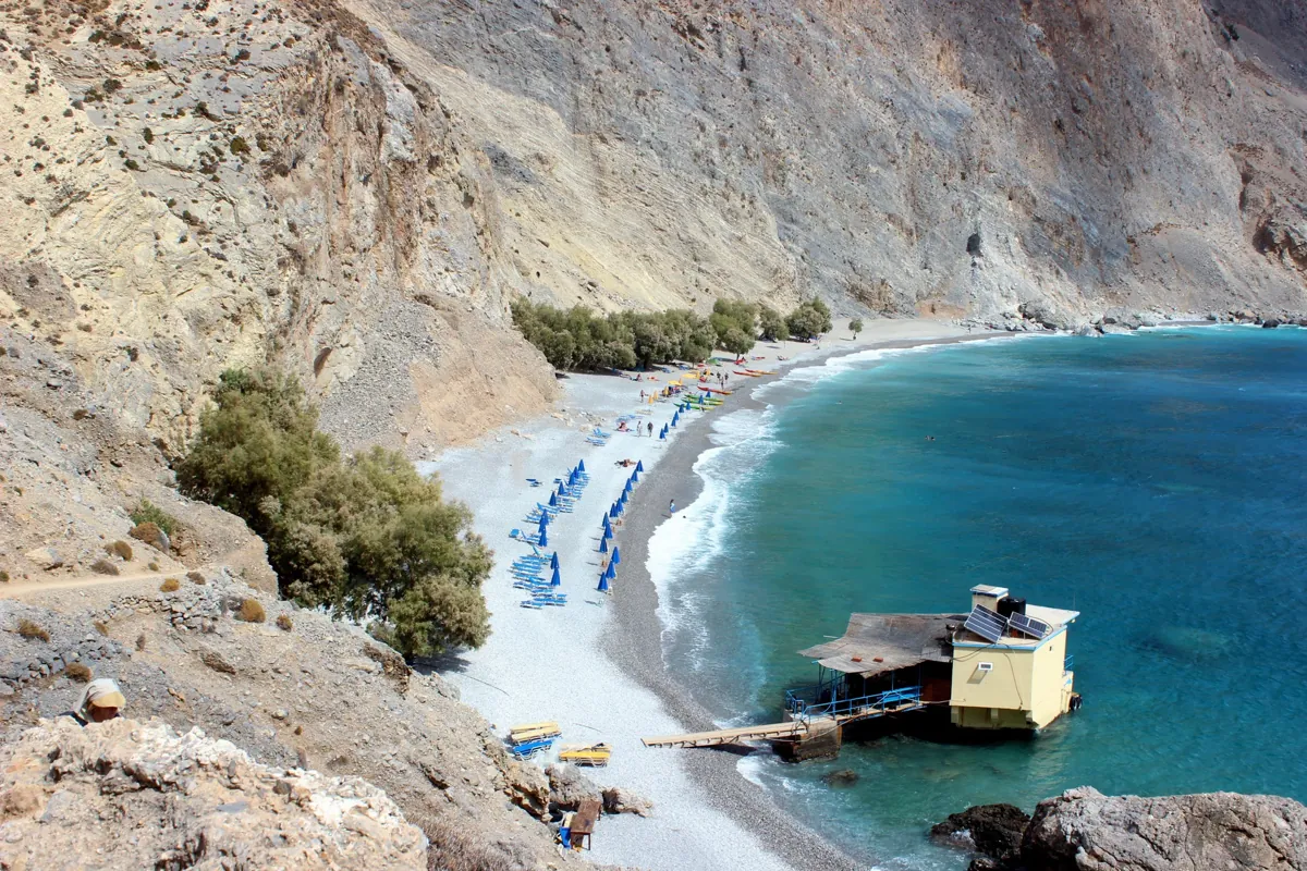 Sweet Water Beach: a pebble cove of turquoise water under steep pale cliffs